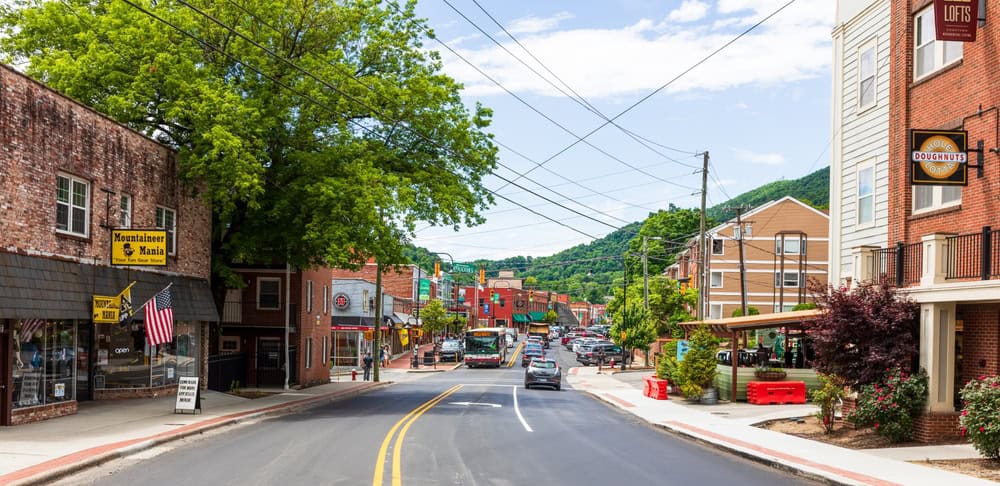 BOONE, NC, USA-20 JUNE 2022: Main Street in Summer. people, cars, businesses. Wide angle.