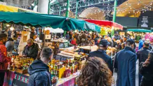 bustling borough market packed with shoppers enjoying fresh food stalls