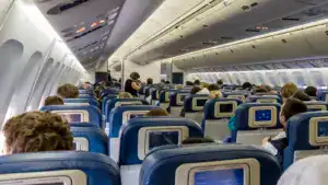 interior of large passengers airplane with people on seats