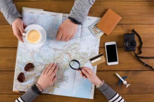 Couple planning travel. Searching for best route on map, preparation for summer vacation, top view