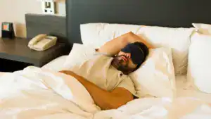 tourist is enjoying a relaxing nap in his hotel room