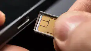 closeup of a person inserting a sim card into the