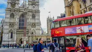 road in front of westminster abbey full of cars buses